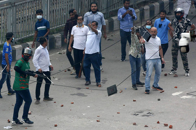 An armed man is seen during clashes at Azompur in Uttara on 4 August afternoon